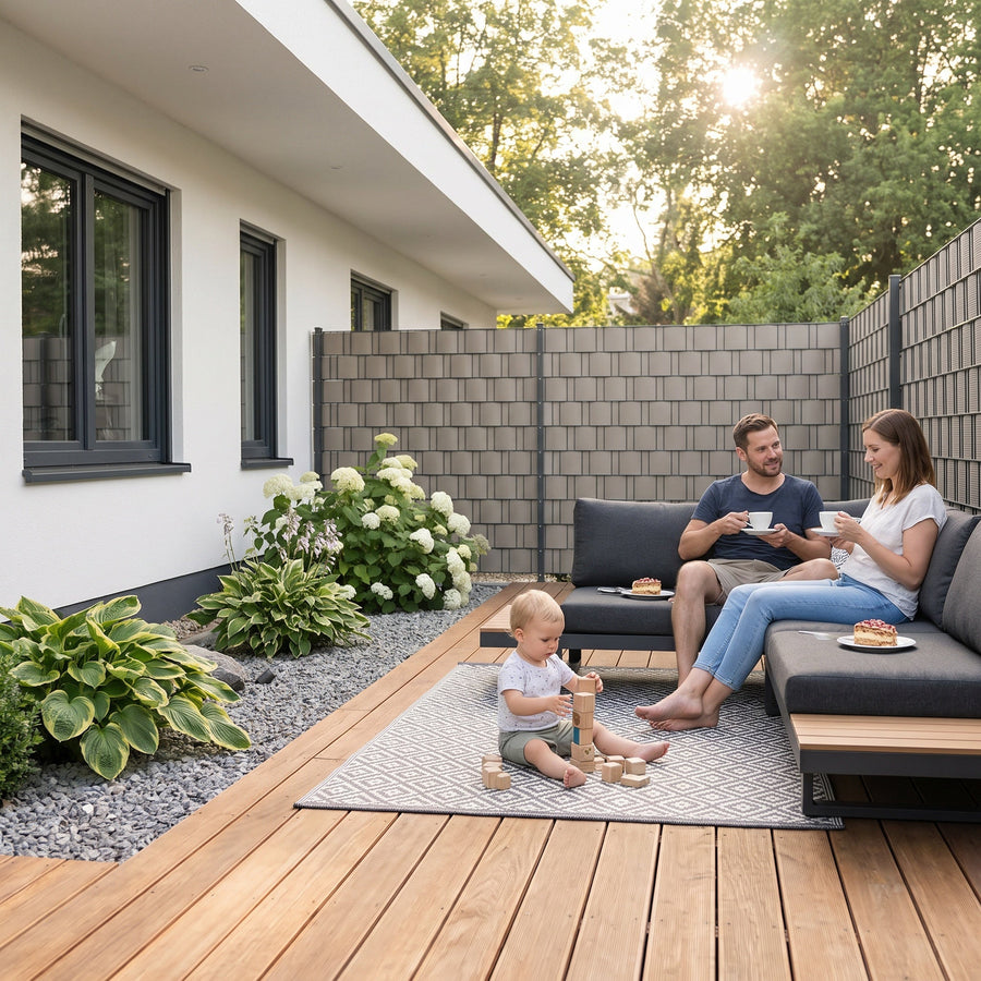 Double bar grating fence with RATTA rattan privacy screen strips in woven look